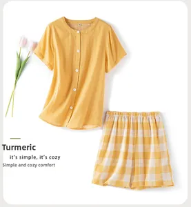 Flat lay of ginger yellow double-layer cotton pajama set with short sleeves and plaid shorts