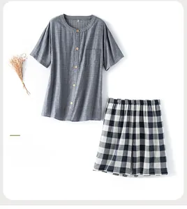Navy blue short-sleeve pajama top with checkered shorts on clean background