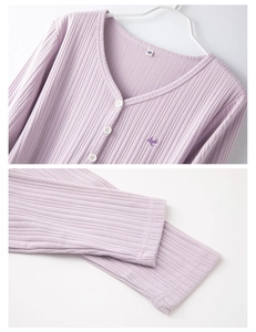 Detailed macro view of lavender ribbed cotton pajama top with bird embroidery and buttons
