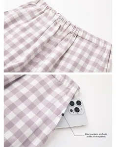 Detail showing elastic waistband and deep side pockets of purple checkered pajama pants
