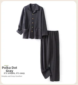 Detail view of grey polka dot quilted men's pajamas featuring a lapel button-down top