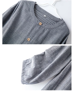 Detail of round collar with wooden buttons and elastic cuffs on gray cotton lounge wear