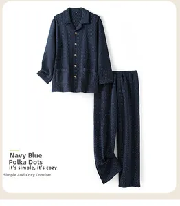 Detail view of navy blue polka dot quilted pajama set with button-down shirt and trousers