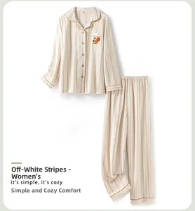 Detail of off-white striped cotton pajama with orange trim and squirrel embroidery