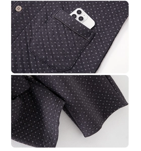 Detail of quilted men's loungewear featuring white polka dots and a functional square pocket