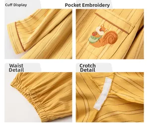 Detail view of cotton striped pajamas showing squirrel embroidery and reinforced seams