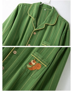Detail of green striped cotton pajama with squirrel embroidery and wooden buttons