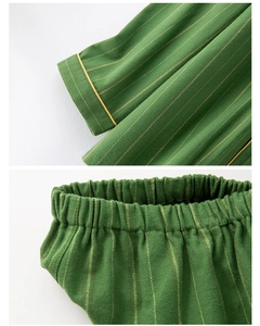 Detailed close-up of green striped cotton pajama cuffs and elasticized waistband texture