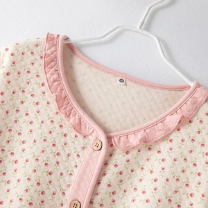 Women's floral quilted pajamas set featuring pink flower patterns and ruffled trim detail