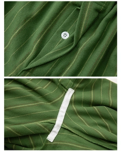 Close-up of green striped cotton pajama set with white buttons and reinforced seams