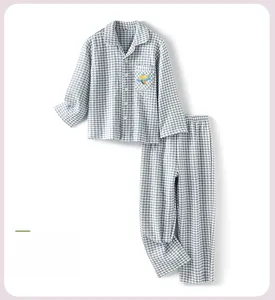 Detail of blue checkered children's pajamas featuring cute airplane embroidery on pocket