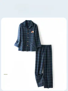 Detail of men's navy blue plaid pajamas with embroidered animal pattern on chest pocket