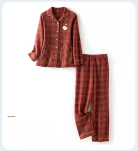 Close-up of quilted red plaid pajama set with yellow piping and cute animal embroidery