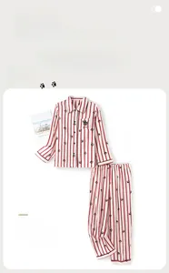 Detail of red striped cotton pajama set featuring black cat embroidery on front pocket