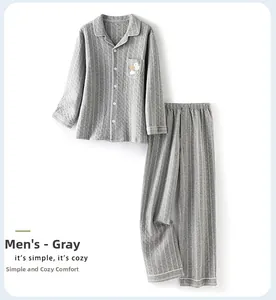 Detail view of men's quilted cotton pajama set in grey with cartoon pocket embroidery