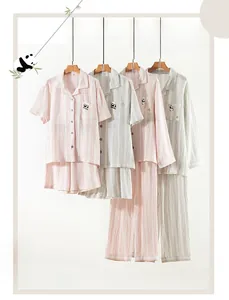 Detail of double gauze cotton pajamas with panda embroidery and soft stripe texture