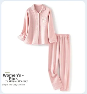Close-up of pink quilted pajama set with animal embroidery and soft diamond pattern