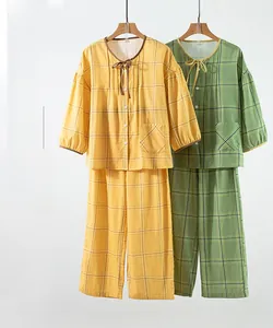 Detail of cotton plaid pajama set featuring 3/4 sleeves and bow-tie neckline