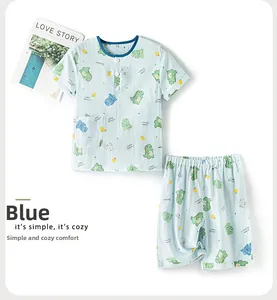 Vue détaillée du pyjama en coton bleu pour enfants avec imprimé dinosaure de dessin animé