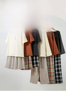 Detail of cotton gauze pajamas showing animal embroidery and buttoned Henley neck design