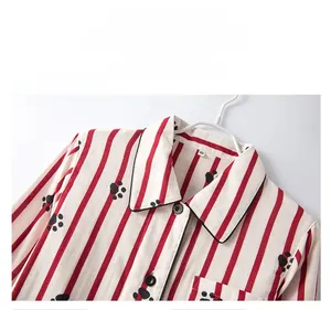 Detail of cotton striped pajamas collar showing cat paw prints and loose buttoned lapel