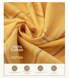 Detail of yellow plaid 100% cotton gauze fabric showing soft texture and breathability