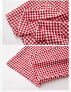 Detail view of cotton flannel loungewear featuring red gingham patterns and wooden buttons