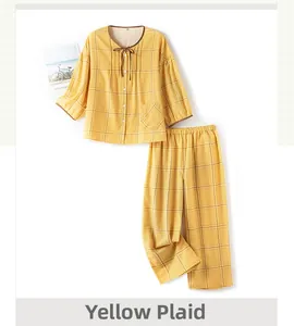 Detail of soft yellow plaid cotton pajama set with button-up top and drawstring neck