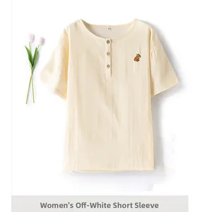 Detail of off-white cotton pajama top with squirrel embroidery and wooden buttons