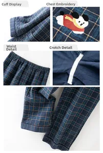 Detail view of quilted blue plaid fabric with cute dog embroidery and elastic waistband