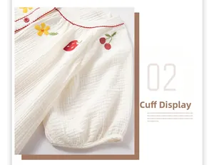 Détail du poignet brodé de fleurs sur le haut de pyjama en coton blanc double couche