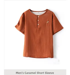 Detail of men's caramel cotton pajama top with henley neck and small animal embroidery