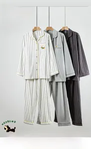 Detailed view of striped brushed cotton pajamas set featuring exquisite dog embroidery on pocket