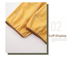 Close-up of yellow plaid cotton pajama cuff with contrast brown piping detail