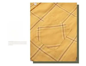 Detail of yellow and white plaid cotton pajama set showing a curved pocket and neat stitching