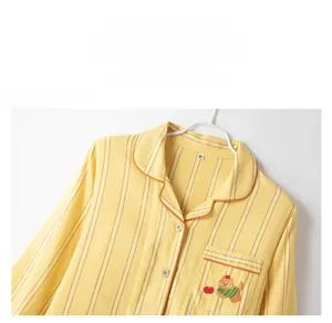 Detail of cotton striped pajama top showing the lapel collar and cute bear embroidery