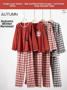 Detail view of cotton flannel pajama sets featuring plaid patterns and cat embroidery