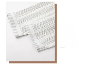 Detail shot of the striped cotton pajama sleeve with soft crinkled texture fabric