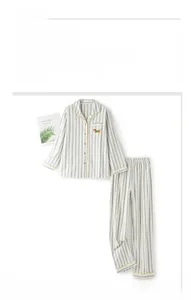 Close-up of striped cotton pajama set with yellow trim and cartoon dog embroidery