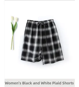 Close-up of women's black and white plaid cotton shorts with elastic waistband and bow tie