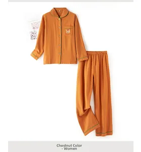 Detail of Chestnut Brown cotton pajama top with cartoon bear embroidery and green piping