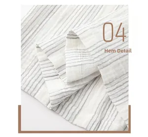 Close-up of the hem detail on white and grey striped cotton gauze pajama top