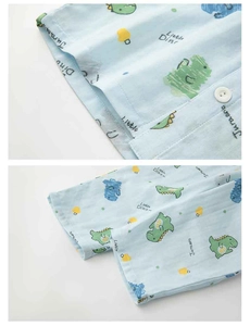 Détail du pyjama en coton bleu clair avec imprimé dinosaure et boutons blancs