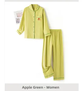 Detail of apple green cotton pajama set for women with bear embroidery and dark green piping