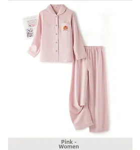 Detail of pink cotton pajamas set featuring long sleeves and bear embroidery on the pocket