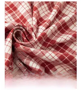 Close-up of 100% cotton red plaid fabric with soft brushed flannel texture and fiber detail