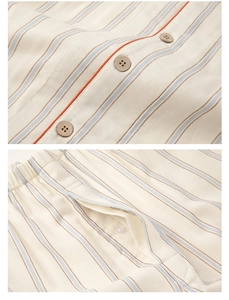 Detail of wooden buttons and orange piping on striped cotton pajama set for couples