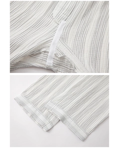 Detail of grey striped cotton pajama pants with reinforced stitching and soft creped fabric