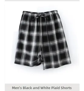 Detail of men's loose cotton shorts featuring black and white checkered pattern and drawstring
