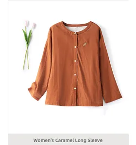 Detail of caramel cotton gauze pajama top with delicate animal embroidery and buttons